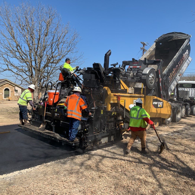 A crew resurfacing a road.